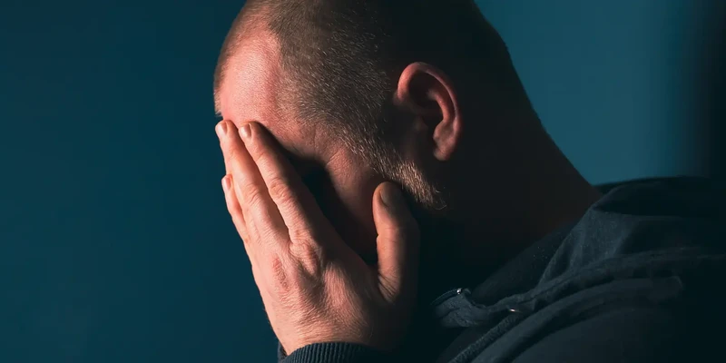 liberty mental health man hands face