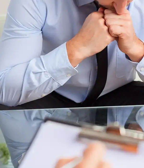 liberty therapy man blue shirt tie sitting desk