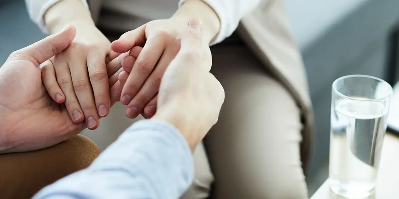 liberty therapy man woman holding hands while sitting couch