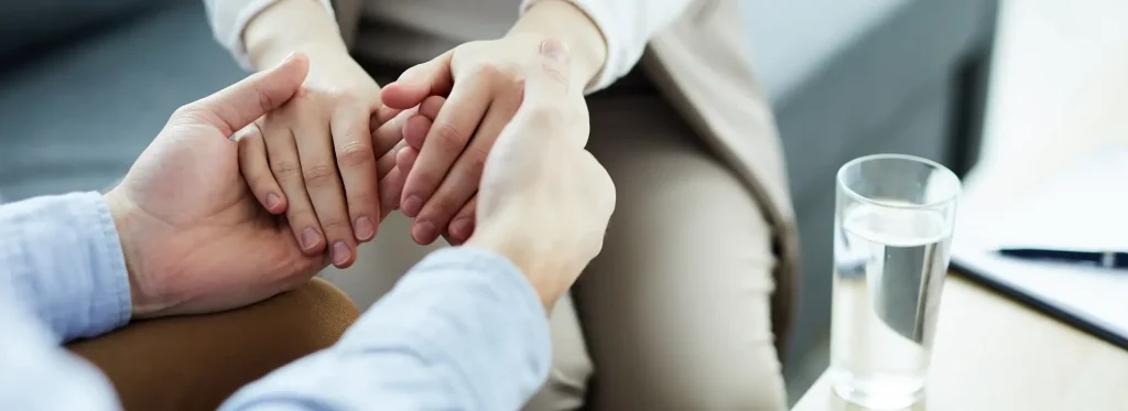 liberty therapy man woman holding hands while sitting table