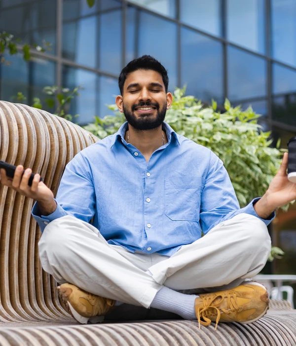 liberty yoga man sitting couch using cell phone