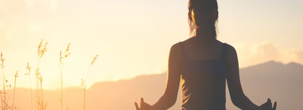 liberty yoga woman meditating field