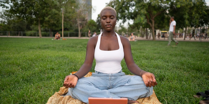 liberty yoga woman sitting grass laptop
